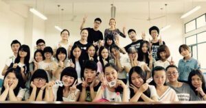 English teacher smiling with students in China