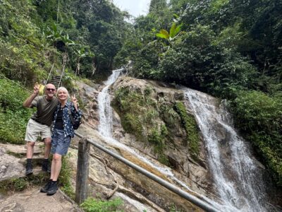 older couple from the UK at a waterfall in Thailand